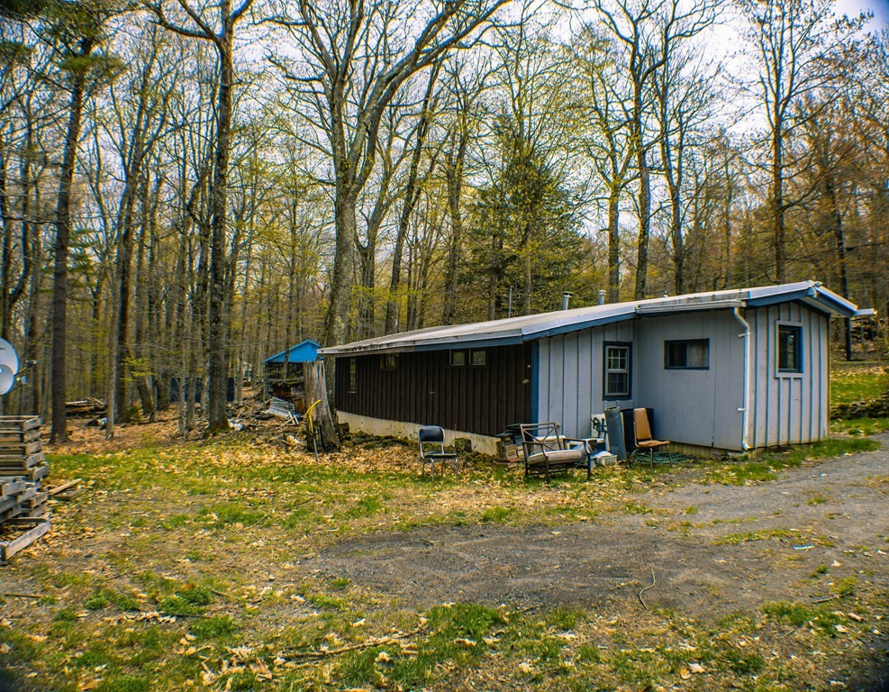 9 Deer Run Path Heath, MA 01346 - Photo 3 of 32 a backyard of a house with table and chairs