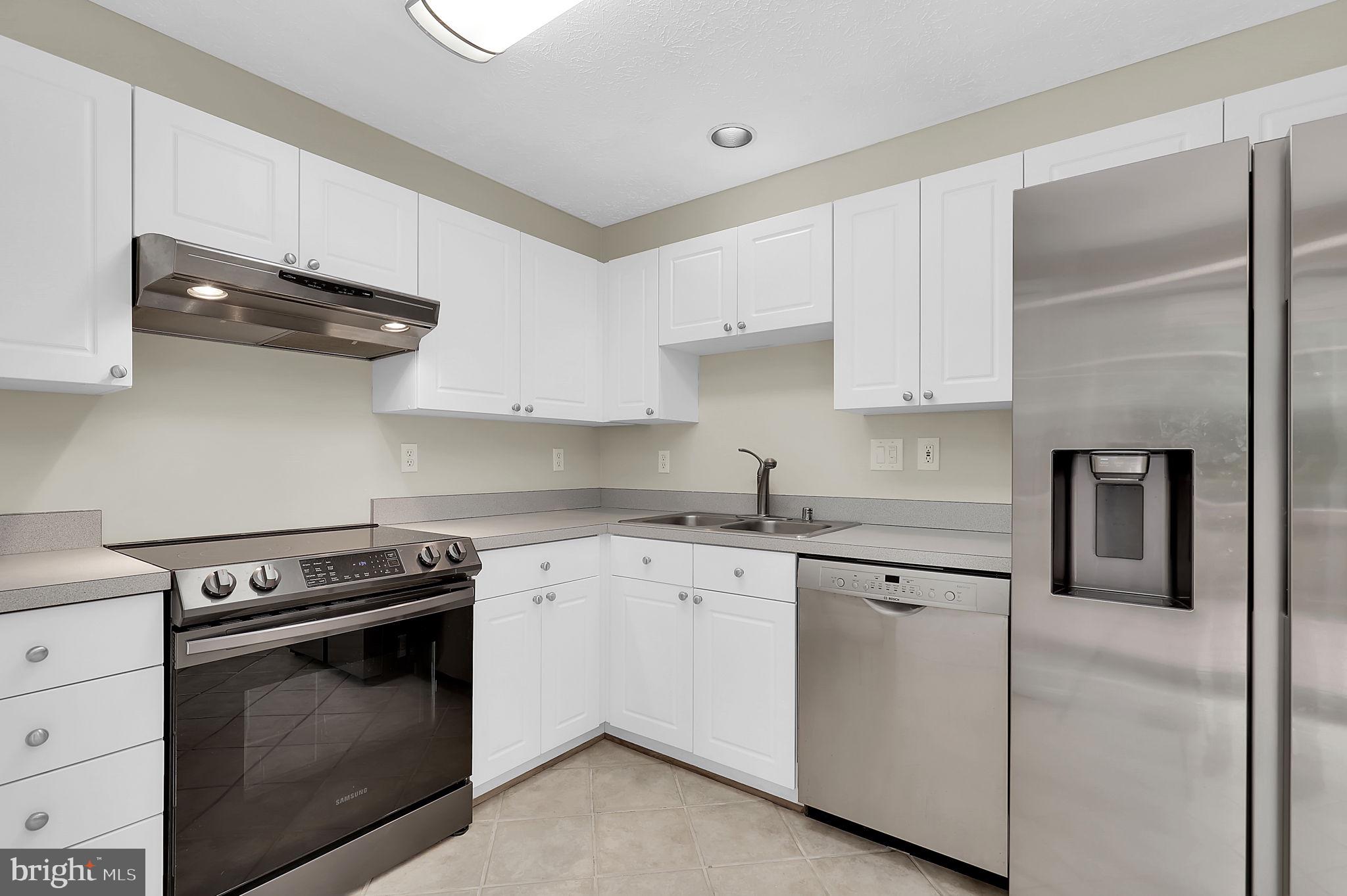 7150 Natures Road Columbia, MD 21046 - Photo 13 of 45 a kitchen with stainless steel appliances granite countertop a sink and a stove