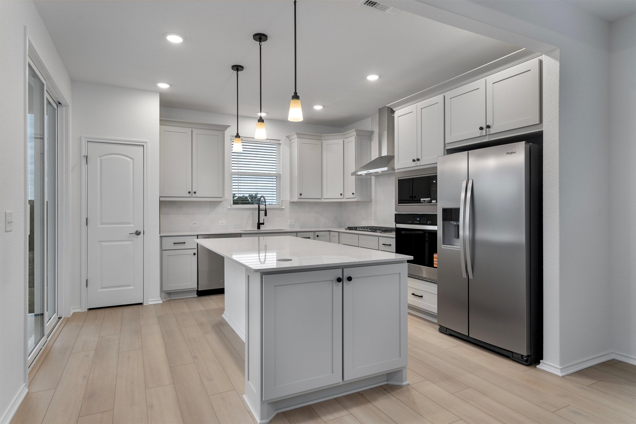 310 Livewater Lane Georgetown, TX 78633 - Photo 13 of 33 a kitchen with stainless steel appliances granite countertop a refrigerator a sink and a stove