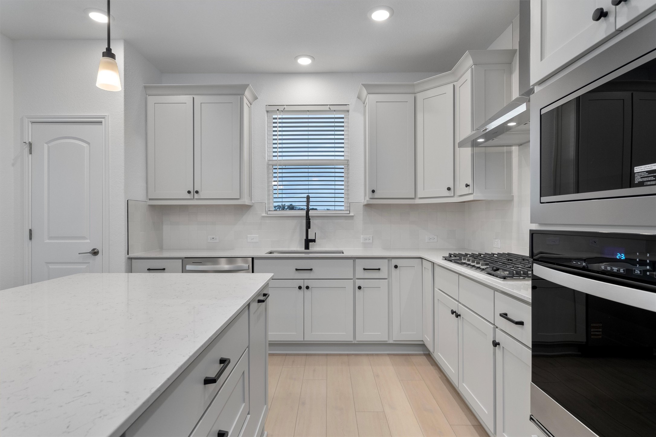 310 Livewater Lane Georgetown, TX 78633 - Photo 14 of 33 a kitchen with stainless steel appliances granite countertop a stove a sink and a microwave