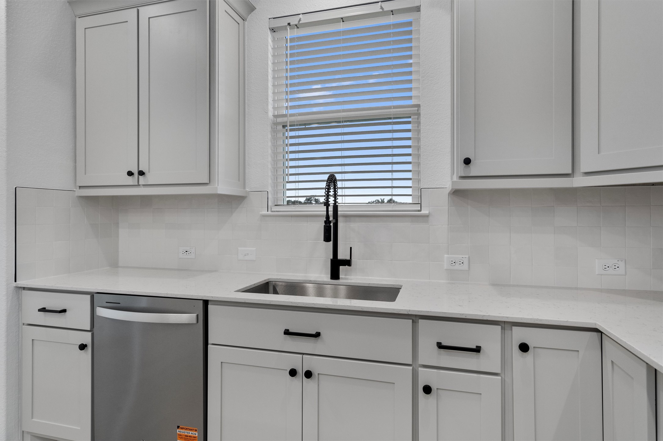 310 Livewater Lane Georgetown, TX 78633 - Photo 15 of 33 a kitchen with white cabinets and a sink