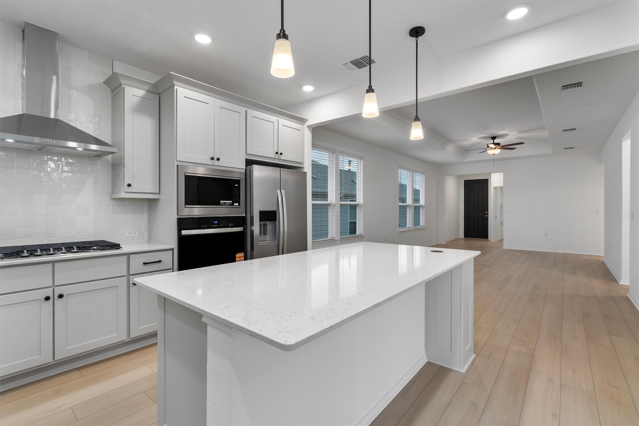 310 Livewater Lane Georgetown, TX 78633 - Photo 17 of 33 a large kitchen with stainless steel appliances a large center island attached withe living room
