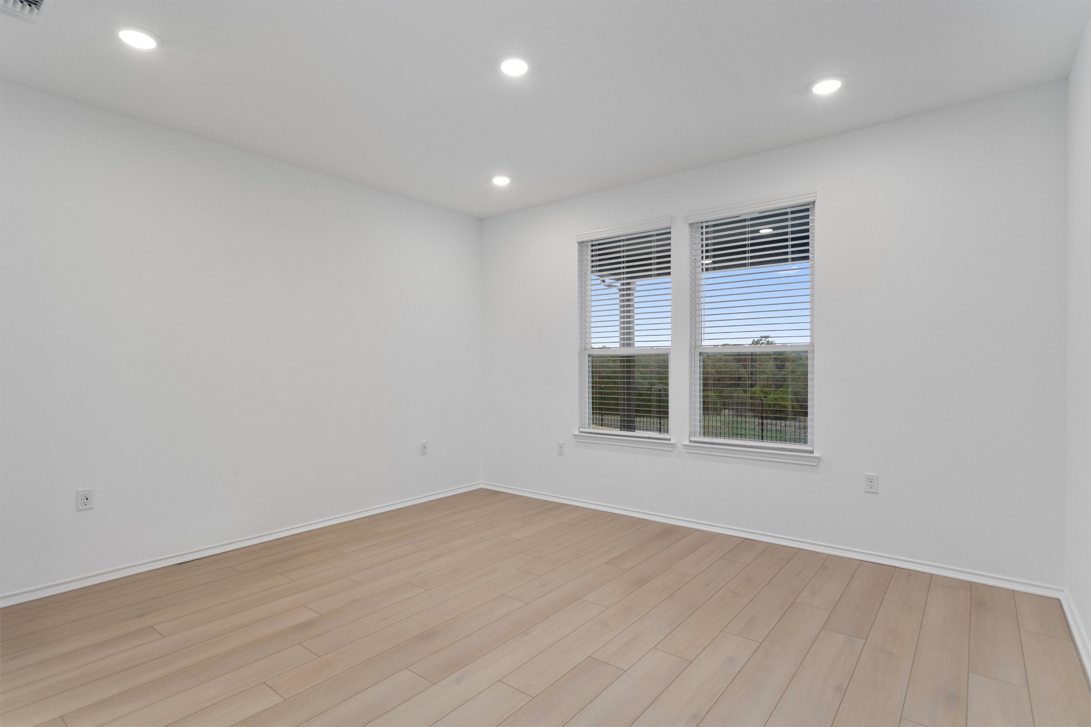 310 Livewater Lane Georgetown, TX 78633 - Photo 18 of 33 an empty room with wooden floor and windows