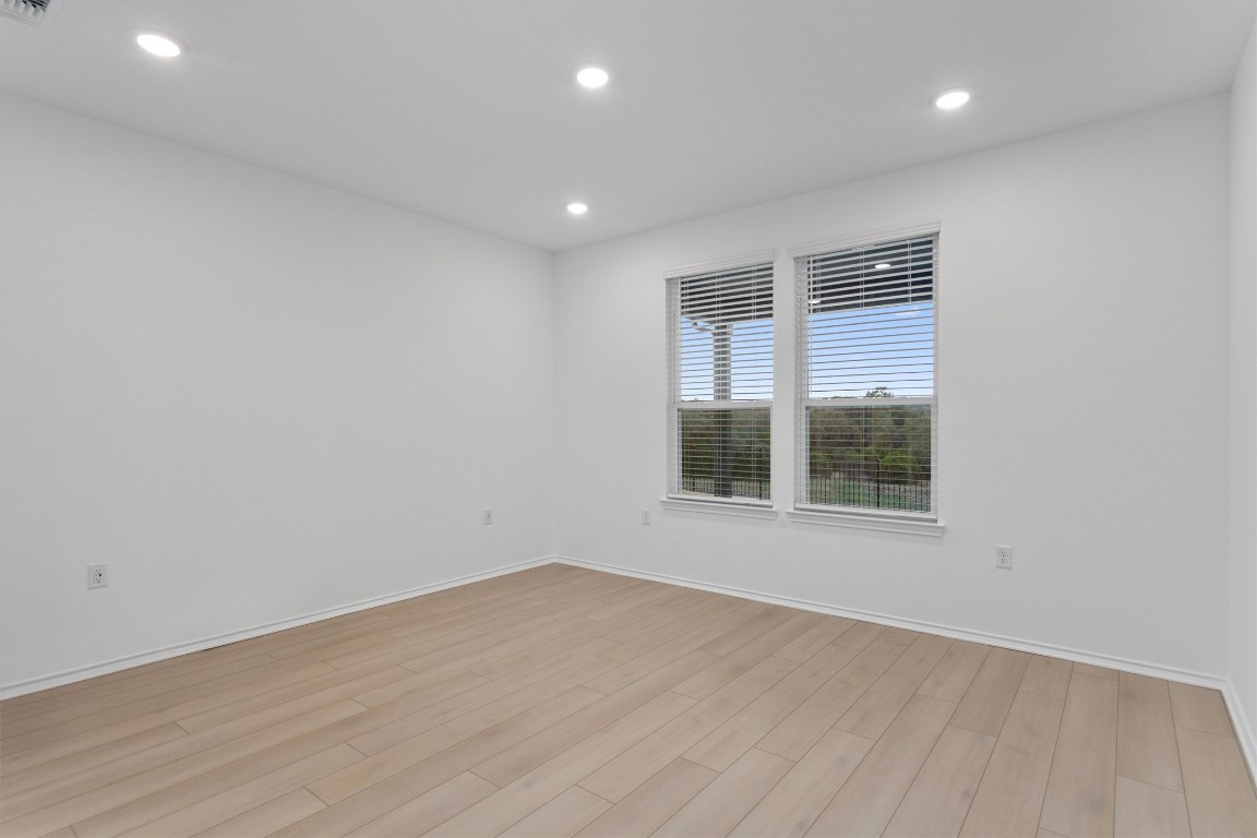 310 Livewater Lane Georgetown, TX 78633 - Photo 18 of 33 an empty room with wooden floor and windows