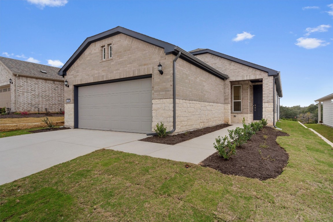 310 Livewater Lane Georgetown, TX 78633 - Photo 2 of 33 a front view of a house with a yard and garage