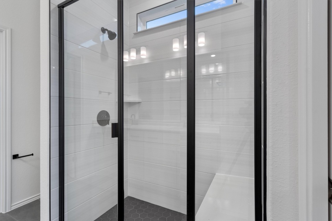 310 Livewater Lane Georgetown, TX 78633 - Photo 22 of 33 a bathroom with a glass shower door