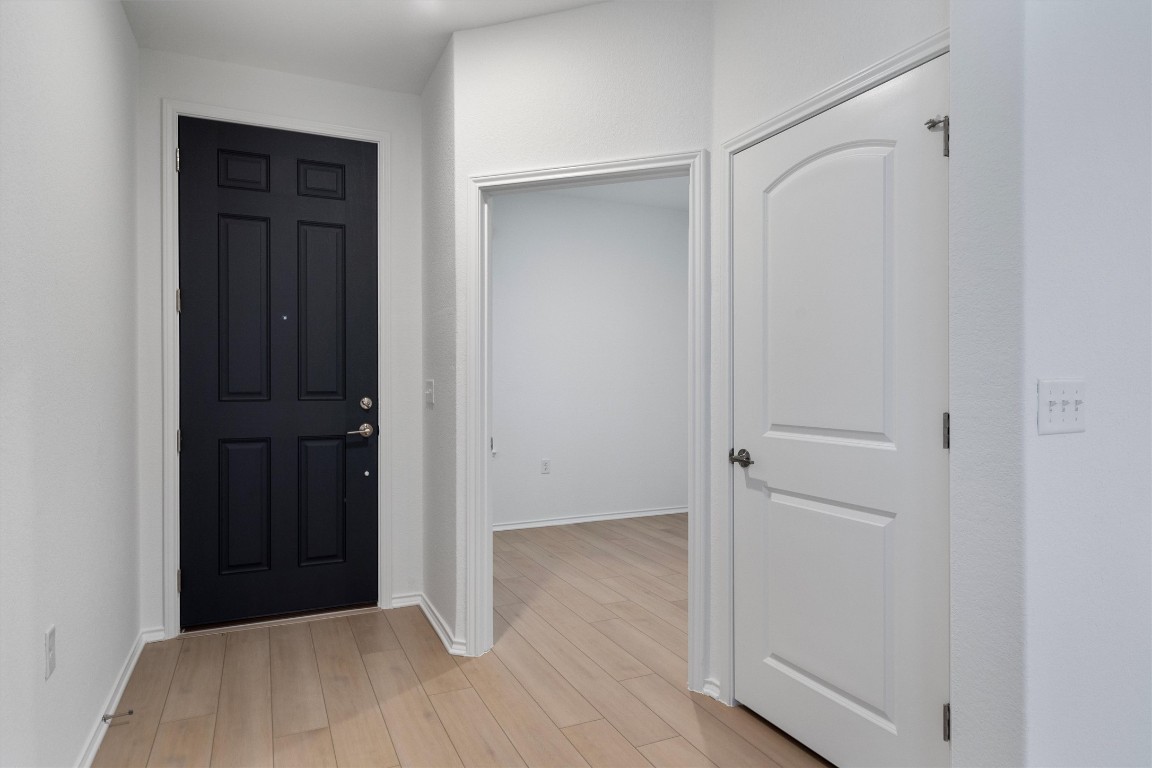 310 Livewater Lane Georgetown, TX 78633 - Photo 6 of 33 a view of a closet area with wooden floor