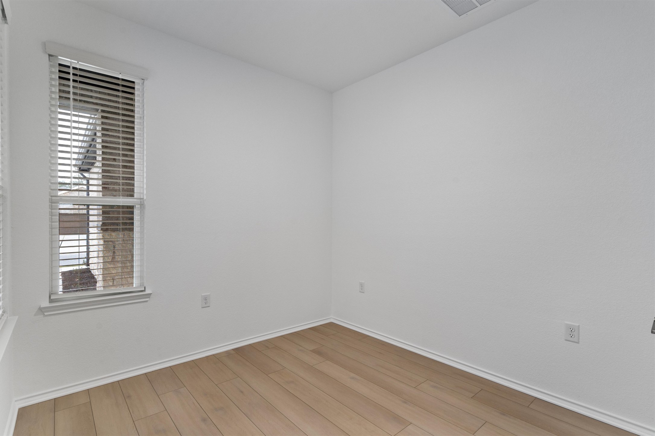 310 Livewater Lane Georgetown, TX 78633 - Photo 7 of 33 a view of an empty room with wooden floor and a window
