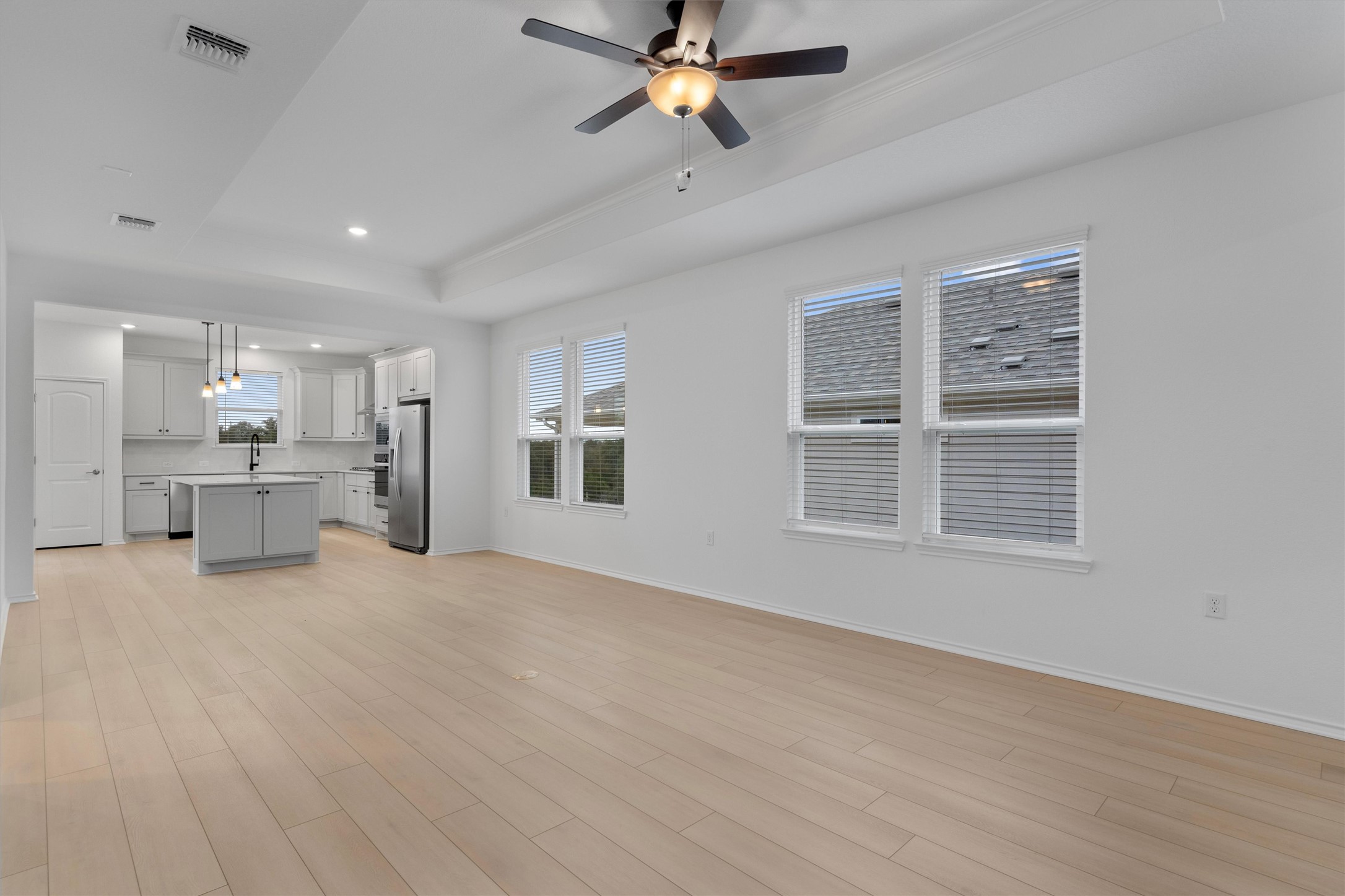 310 Livewater Lane Georgetown, TX 78633 - Photo 9 of 33 a view of an empty room with a window and a kitchen