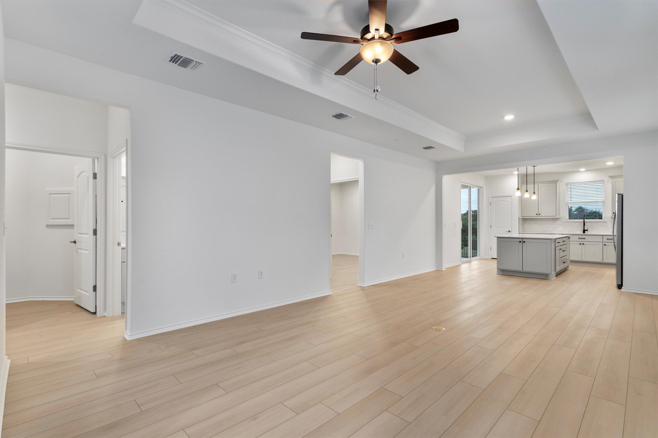 310 Livewater Lane Georgetown, TX 78633 - Photo 10 of 33 a view of a livingroom with hardwood floor and a ceiling fan