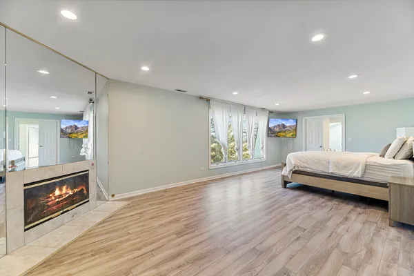 a large bathroom with a tub shower and sink