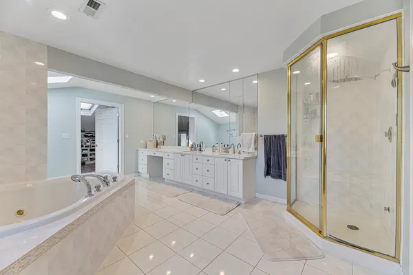 a spacious bathroom with a granite countertop sink mirror and shower