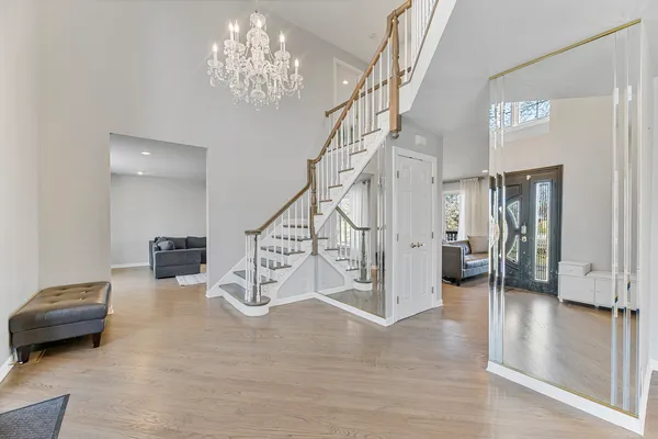 a view of entryway and hall with wooden floor
