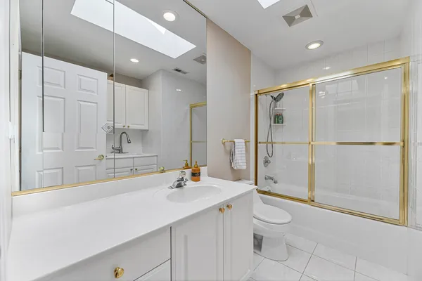 a spacious bedroom with a bed and wooden floor