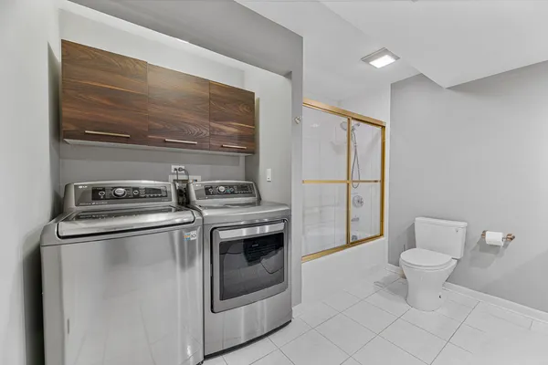 a balcony with wooden floor table and chairs