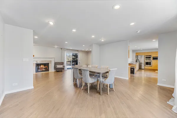 a dining room with furniture and wooden floor