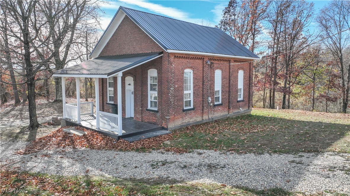 67480 Barnesville Hendrysburg Road Barnesville, OH 43713 - Photo 3 of 16 View of property exterior with a porch