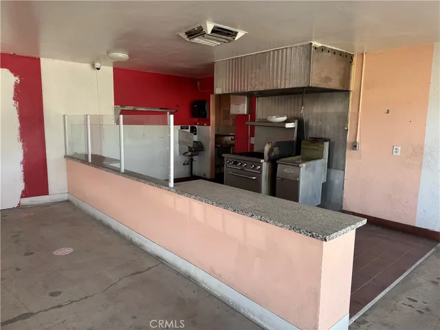 a kitchen with granite countertop a refrigerator and a stove