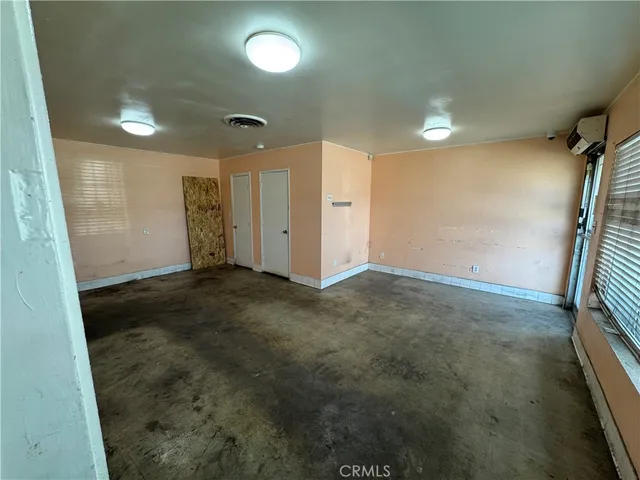 a view of an empty room and a window