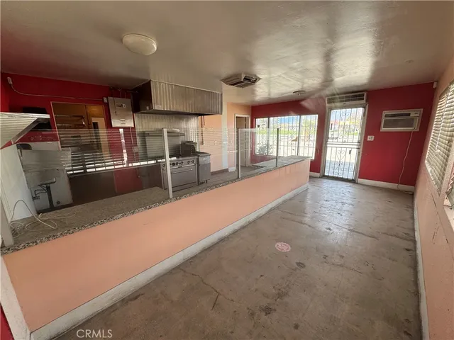 a view of a kitchen with large windows