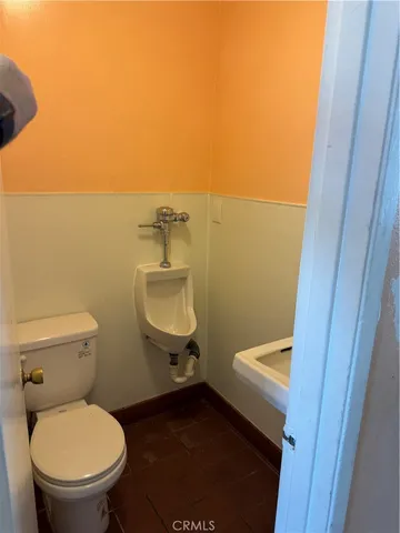 a white toilet sitting next to a small sink