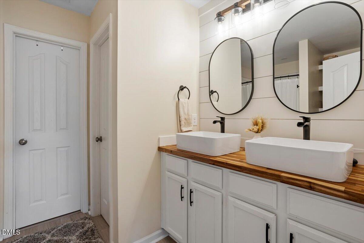 205 Battery Way Bunnlevel, NC 28323 - Photo 28 of 37 a bathroom with a sink and a mirror