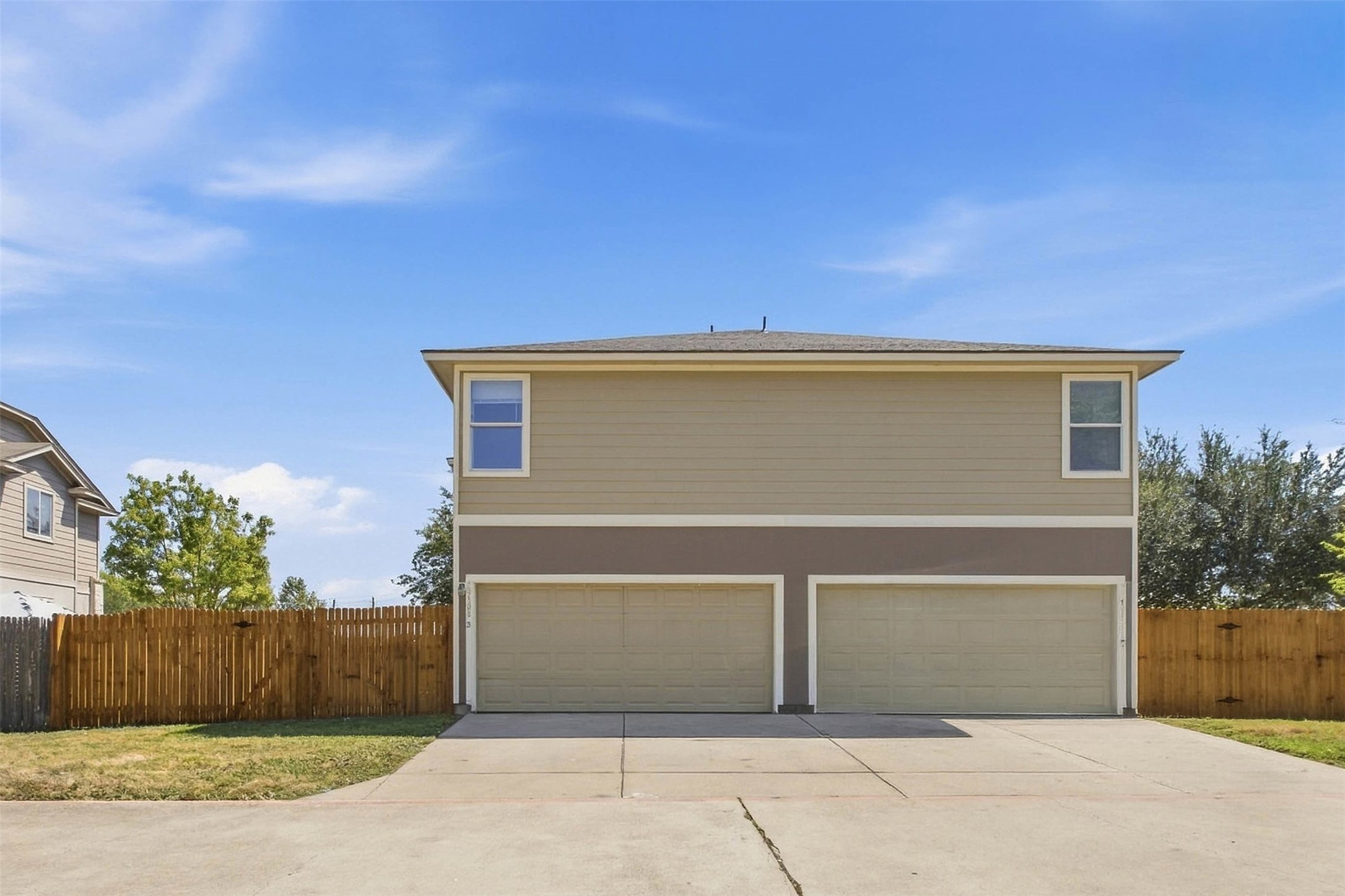 13808 Harris Ridge Boulevard, Unit B Pflugerville, TX 78660 - Photo 32 of 33 Ample concrete driveway space leads to the attached multi-car garage beneath a neat exterior facade.