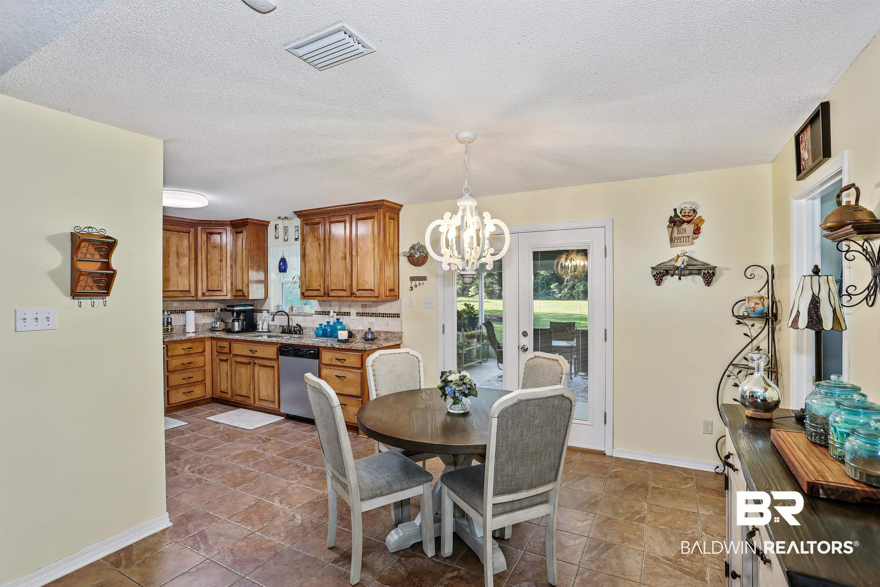 32334 Riverlake Road Seminole, AL 36574 - Photo 20 of 47 Dining area with a chandelier and a textured ceiling
