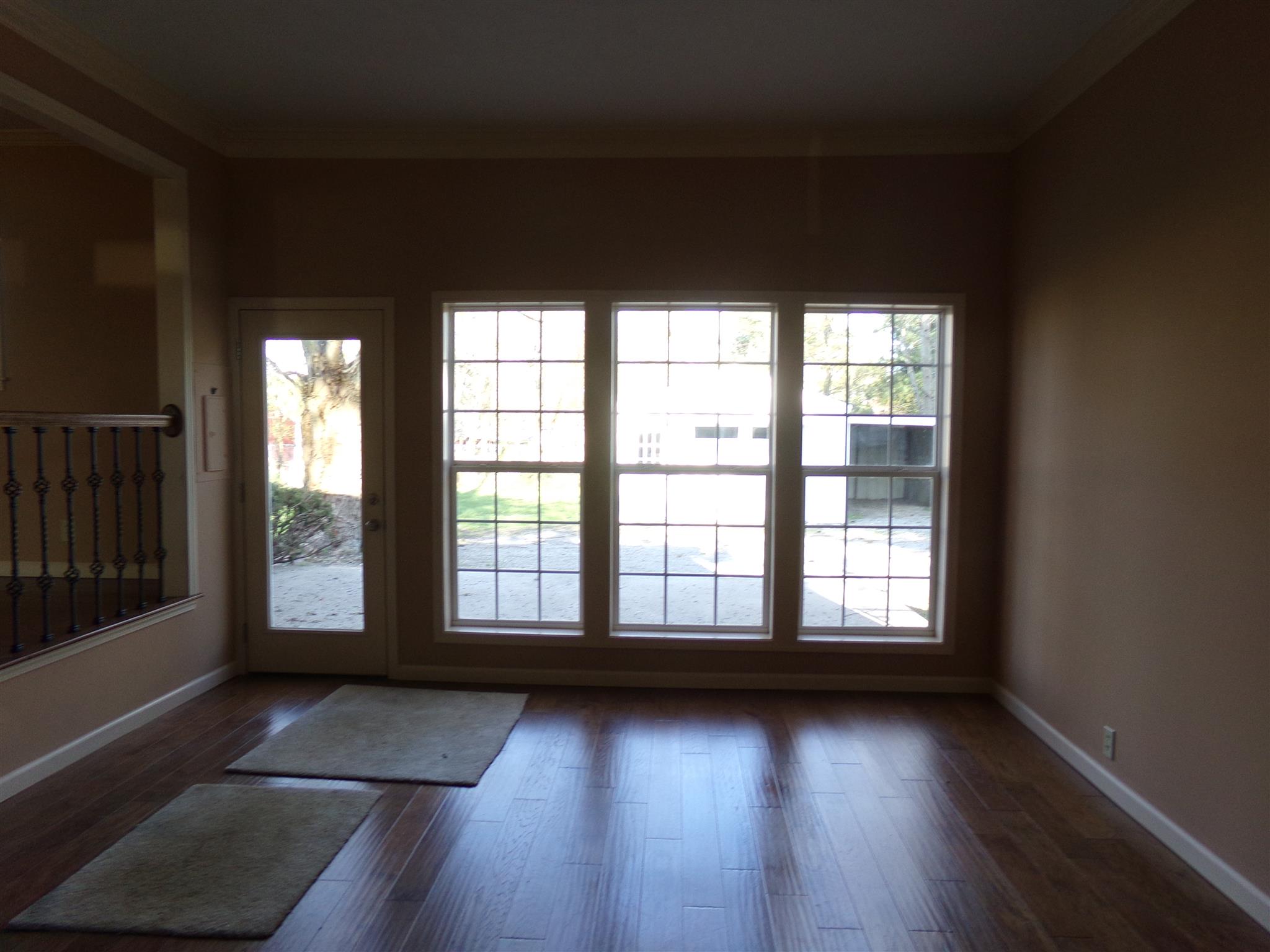 213 Airport Road Portland, TN 37148 - Photo 3 of 16 an empty room with wooden floor and windows