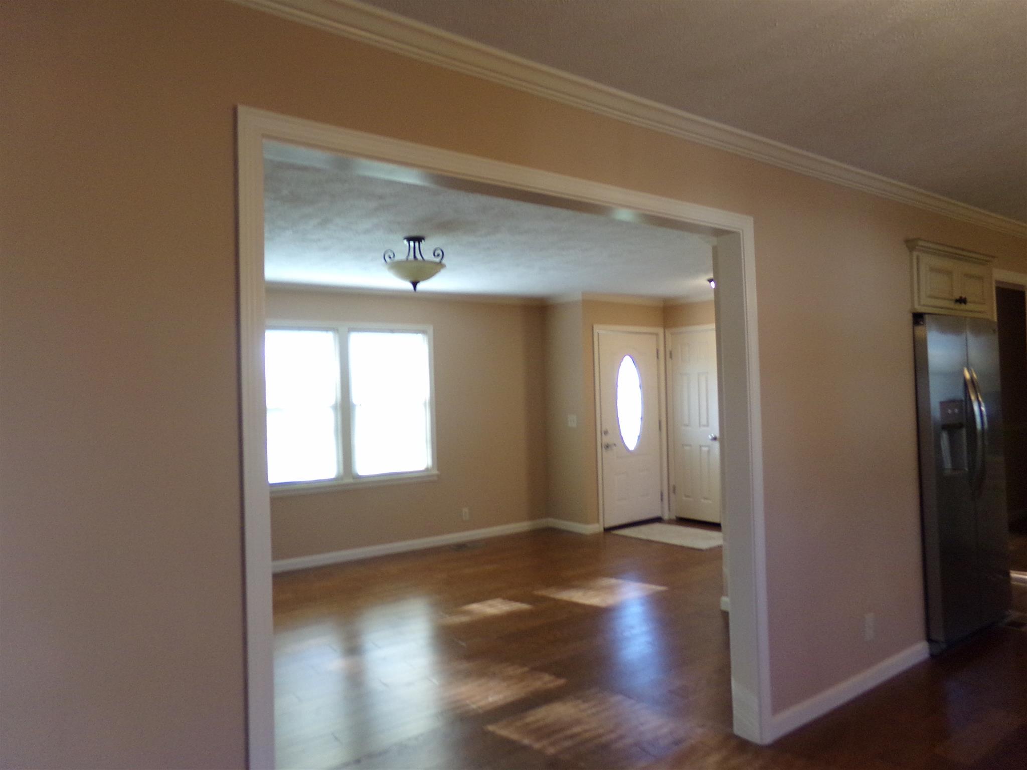 213 Airport Road Portland, TN 37148 - Photo 5 of 16 an empty room with wooden floor and windows