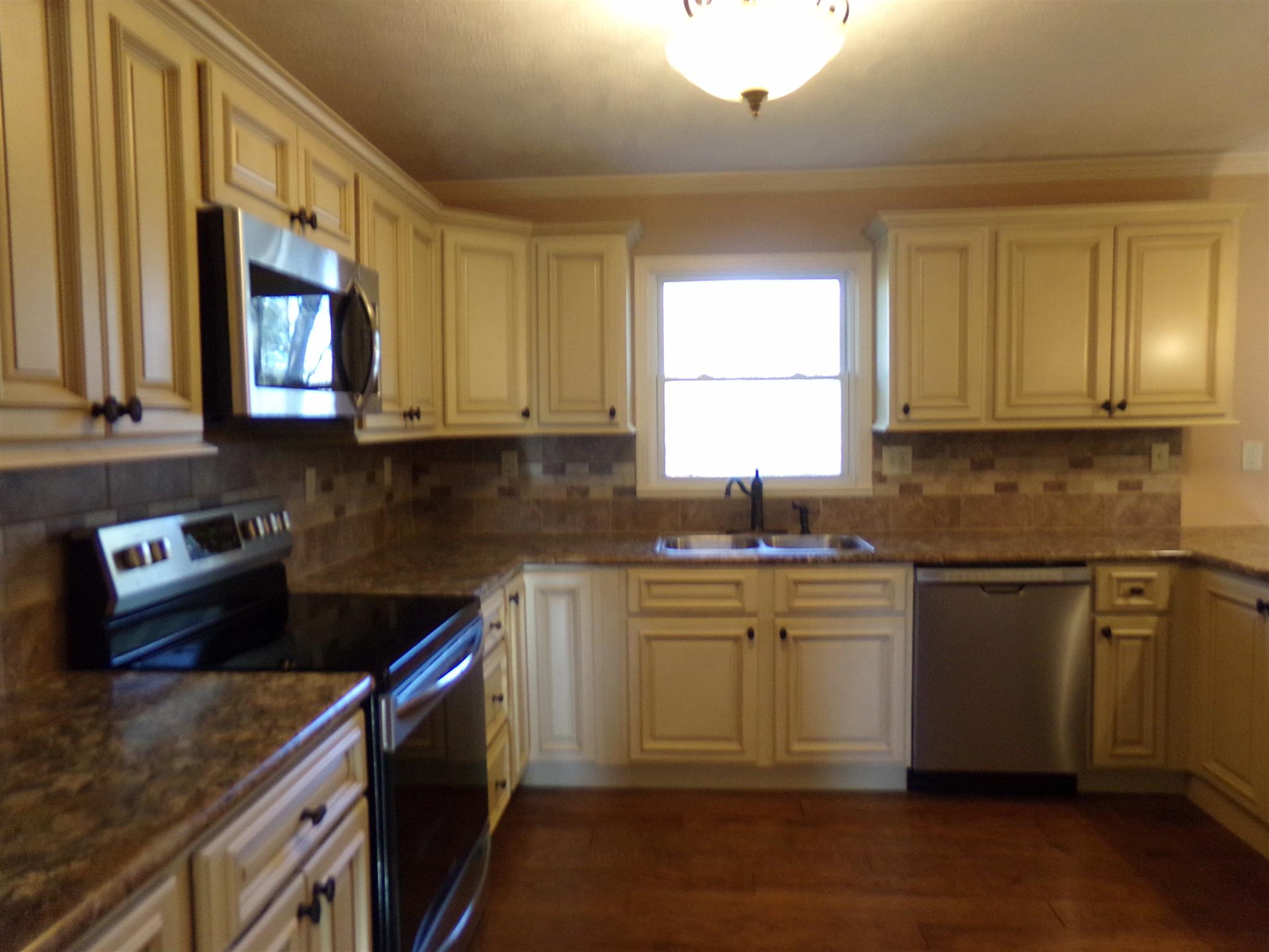 213 Airport Road Portland, TN 37148 - Photo 8 of 16 a kitchen with stainless steel appliances granite countertop a sink stove and cabinets