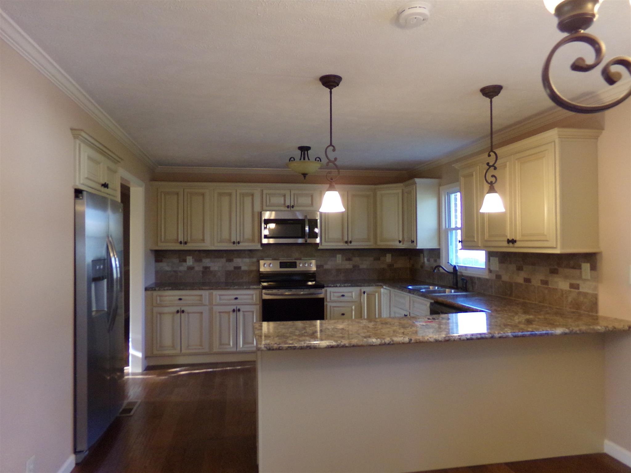 213 Airport Road Portland, TN 37148 - Photo 9 of 16 a kitchen with stainless steel appliances granite countertop a sink a stove and a refrigerator