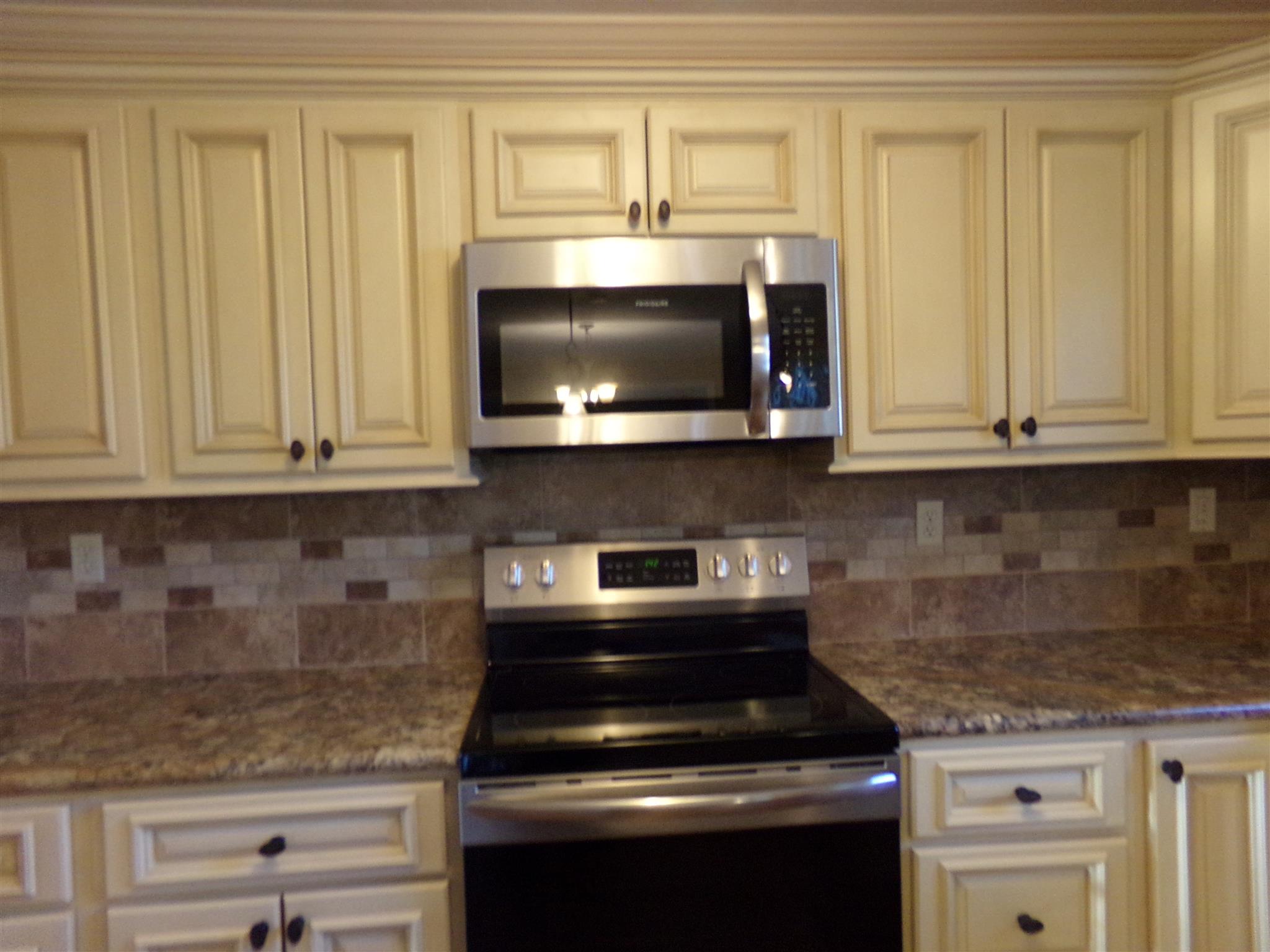 213 Airport Road Portland, TN 37148 - Photo 10 of 16 a kitchen with granite countertop white cabinets stainless steel appliances and a counter space