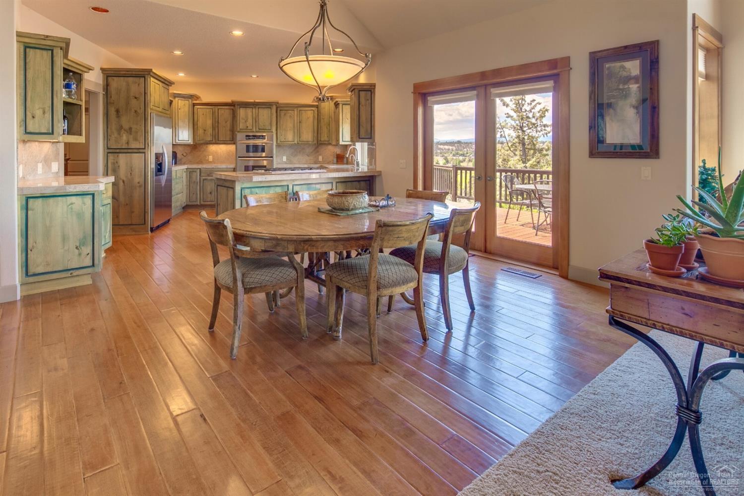 20152 Tumalo Road Bend, OR 97703 - Photo 11 of 25 a view of a dining room with furniture window and wooden floor