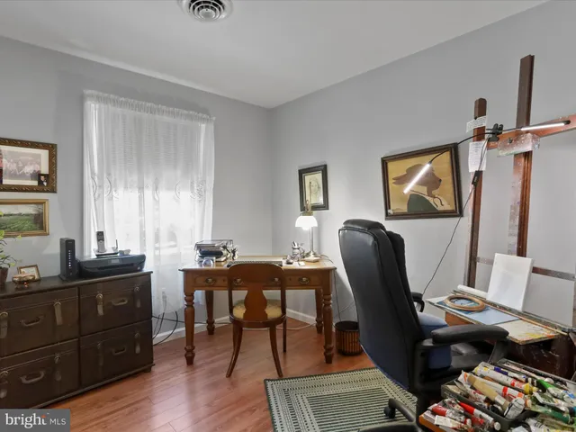 a view of a workspace with furniture and a window
