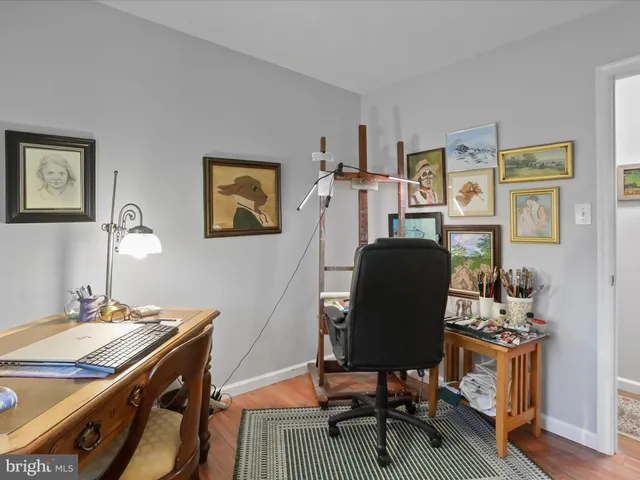 a view of a workspace with furniture and lounge chair