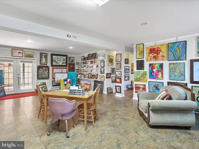 a living room with fireplace furniture and a book shelf