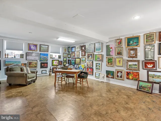 a living room with furniture and a book shelf