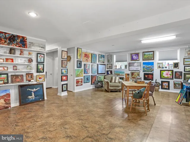 a living room with furniture and a book shelf