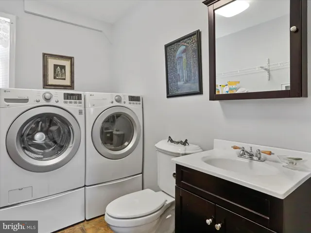 a bathroom with a sink a mirror and a toilet