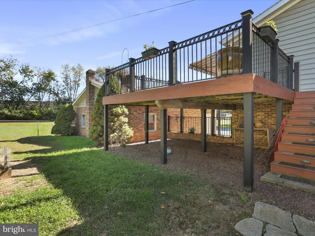 a view of a house with backyard porch and sitting area