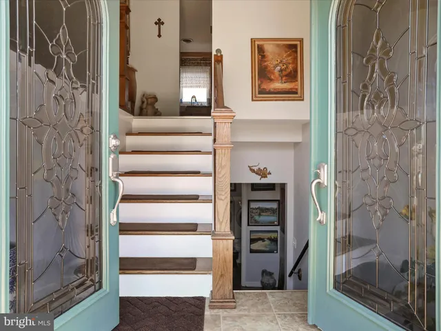a view of a hallway with wooden floor and windows