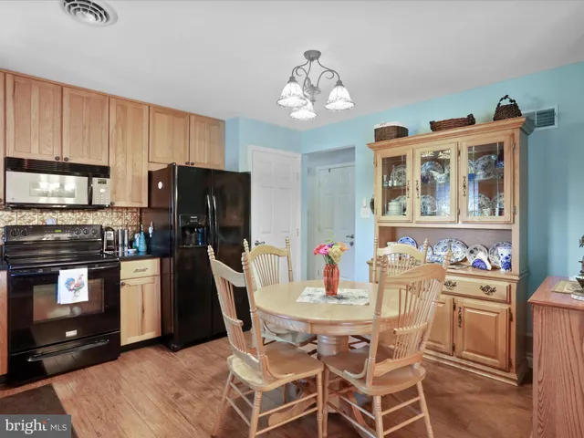 a view of a dining room with furniture and chandelier