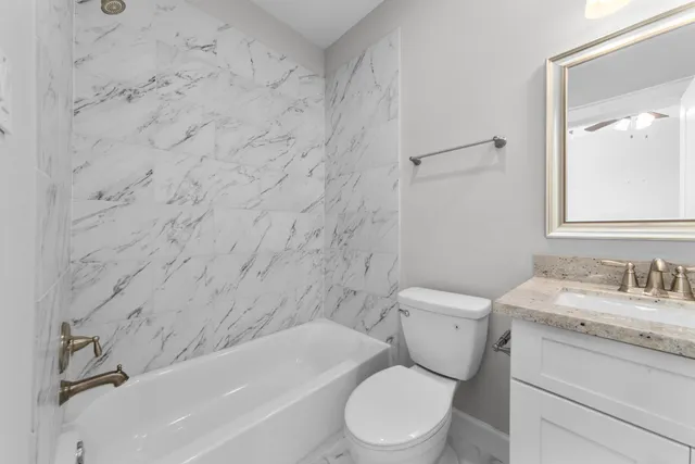 a bathroom with a toilet a sink and bathtub