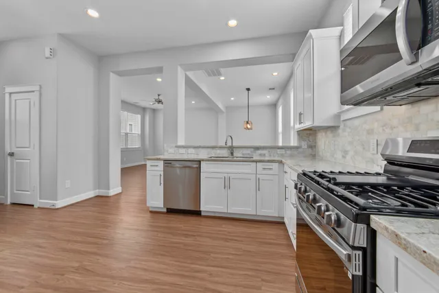 a kitchen with a stove a sink and a refrigerator