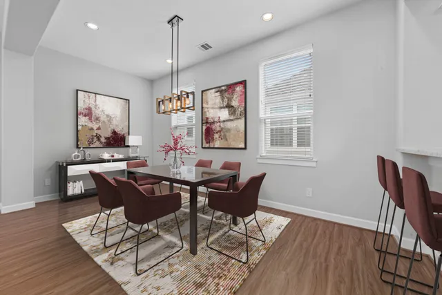 a view of a dining room with furniture window and wooden floor