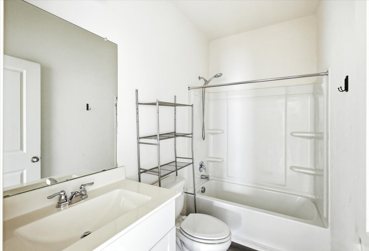 202 Peridot Pass Maxwell, TX 78656 - Photo 16 of 21 A pristine bathroom features a classic bathtub-shower combination and a clean vanity with ample counter space.
