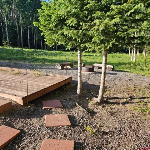a view of a backyard with large trees