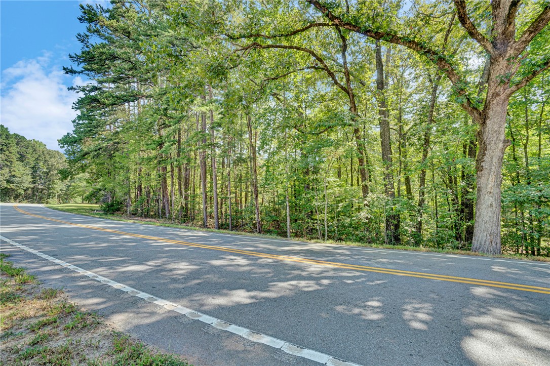 0 Burnt Tanyard Road West Union, SC 29696 - Photo 5 of 7 Mature trees frame the paved road bordering this peaceful wooded property.