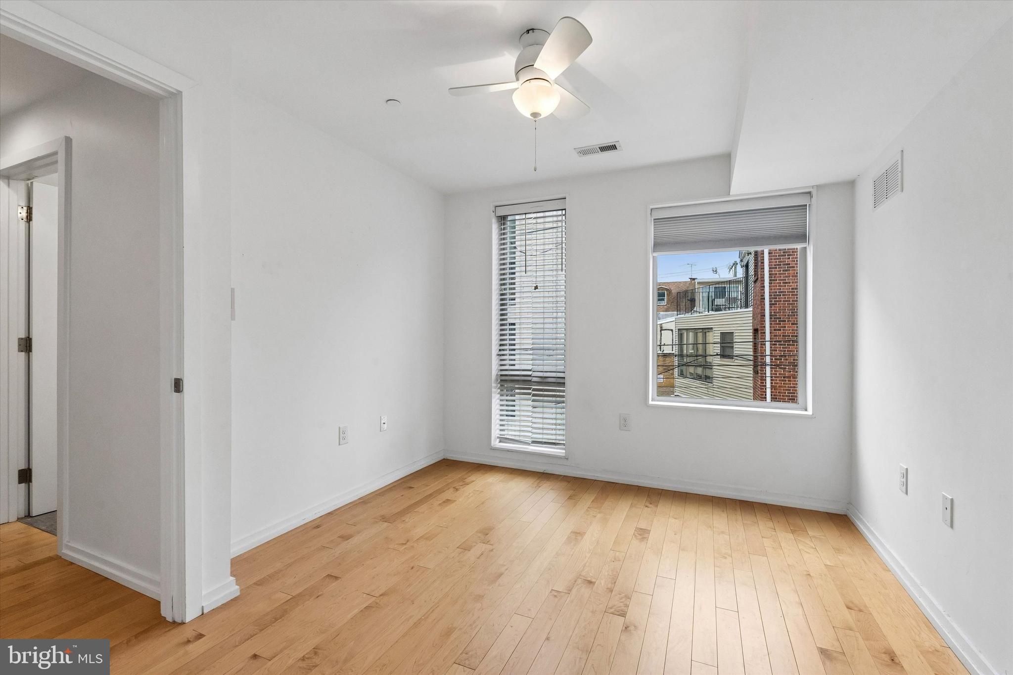 936 North Leithgow Street Philadelphia, PA 19123 - Photo 11 of 40 a view of an empty room with a window and wooden floor